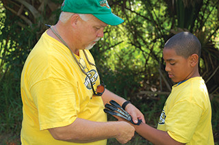 Officer teaching student during summer program